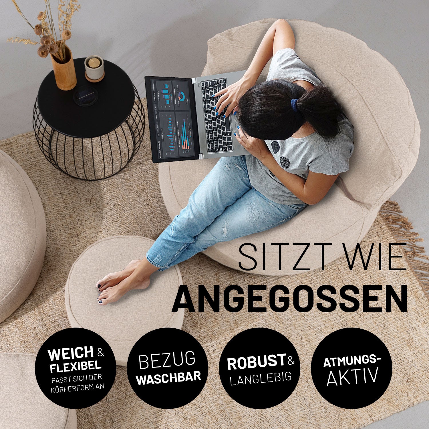 Eine Frau sitzt auf dem atmungsaktiven Sitzsack-Sofa und hat ihre Füße auf dem passenden Hocker abgelegt.