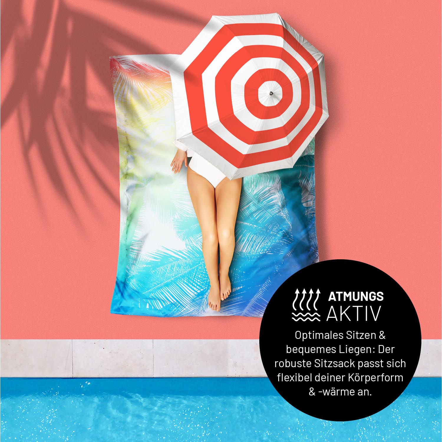 Eine Frau liegt unter einem Sonnenschirm am Pool auf dem Sitzsack Tropical - "Atmungsaktiv - Passt sich Körperform & -wärme an".